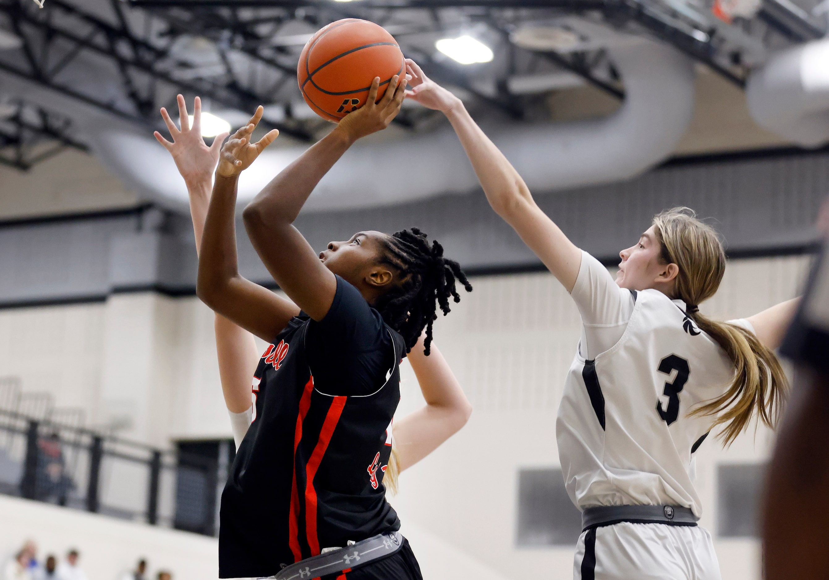 Denton Guyer guard Madison McGhie (3)  blocks a shot by Denton Braswell center Amaya...