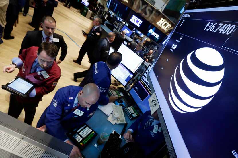 FILE - In this Monday, May 19, 2014, file photo, traders gather at the post that handles...