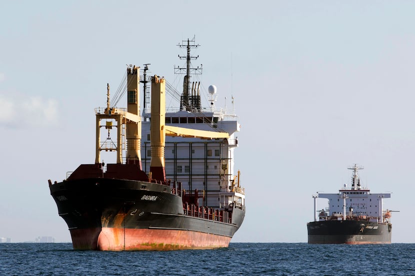FILE - In this June 28, 2013 file photo, the container ship Baghira, foreground, and the oil...