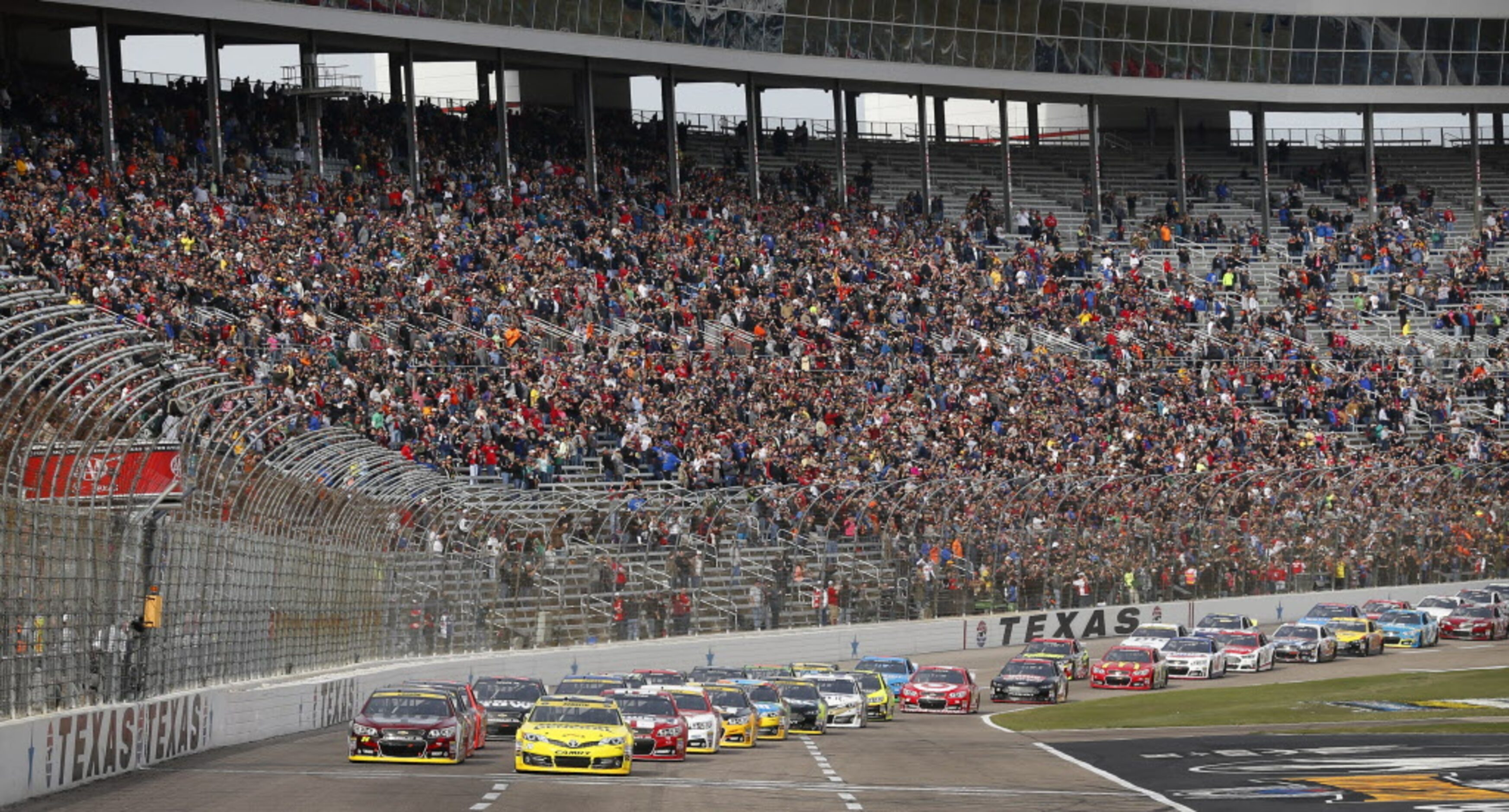 The green flag drops on the start of the AAA Texas 500 as the field of cars race down the...