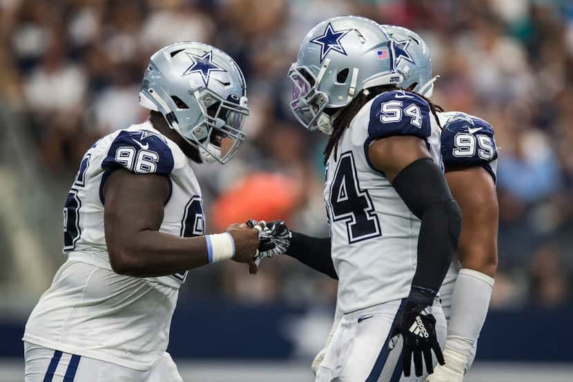 Dallas Cowboys defensive tackle Maliek Collins (96), middle linebacker Jaylon Smith (54) and...
