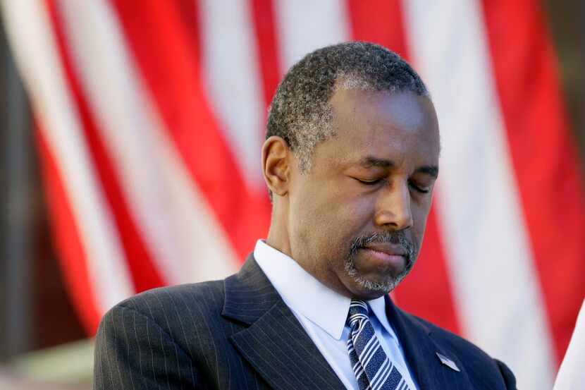  Republican presidential candidate Dr. Ben Carson bows his head in prayer before speaking at...