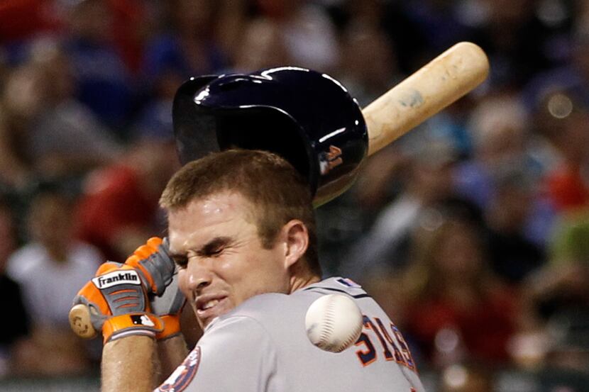 Max Stassi is hit in the face by a pitch thrown by Texas' Tanner Scheppers. (AP Photo/Jim...