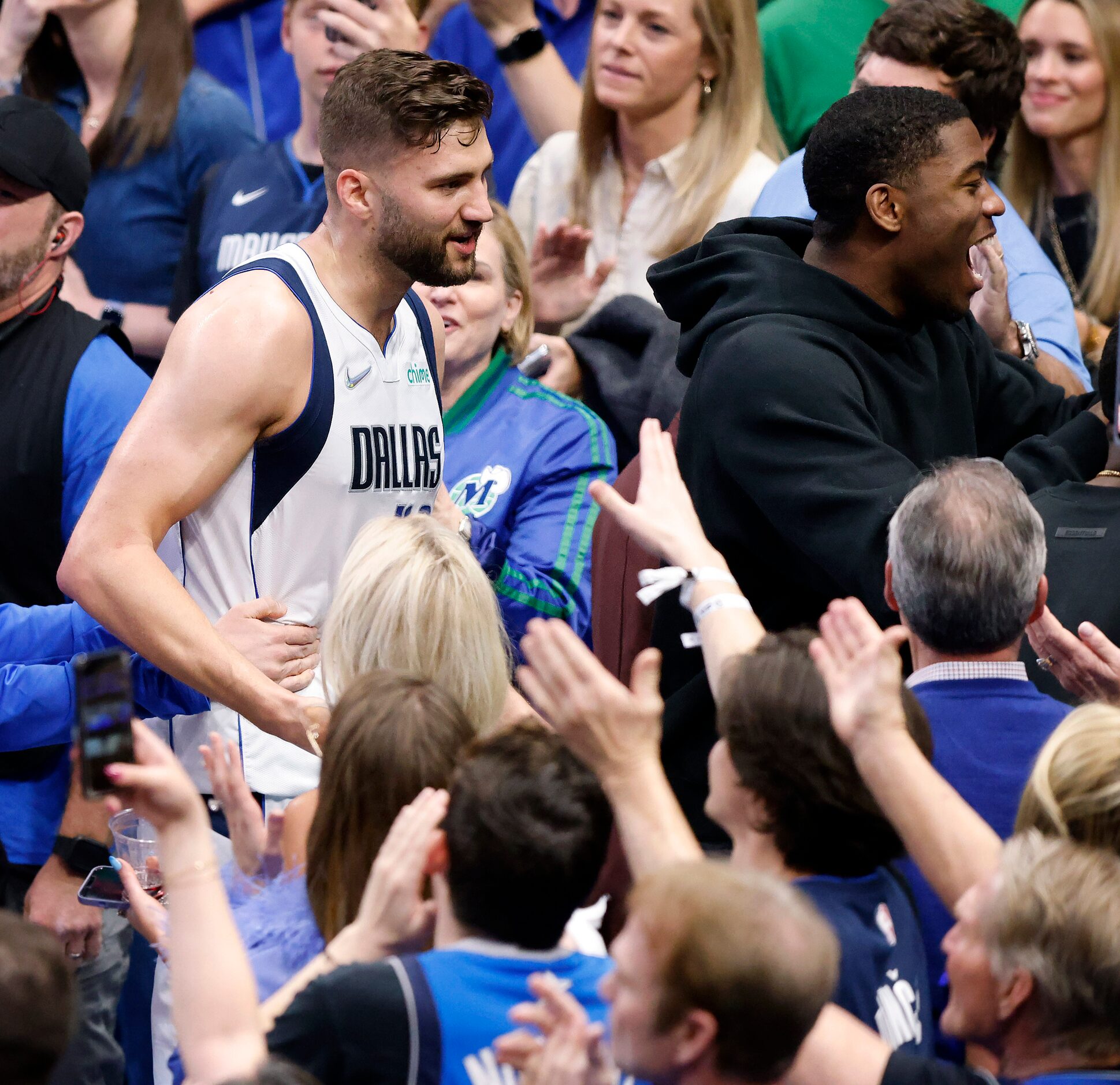 Dallas Mavericks forward Maxi Kleber (left) is congratulated by fans after their win over...