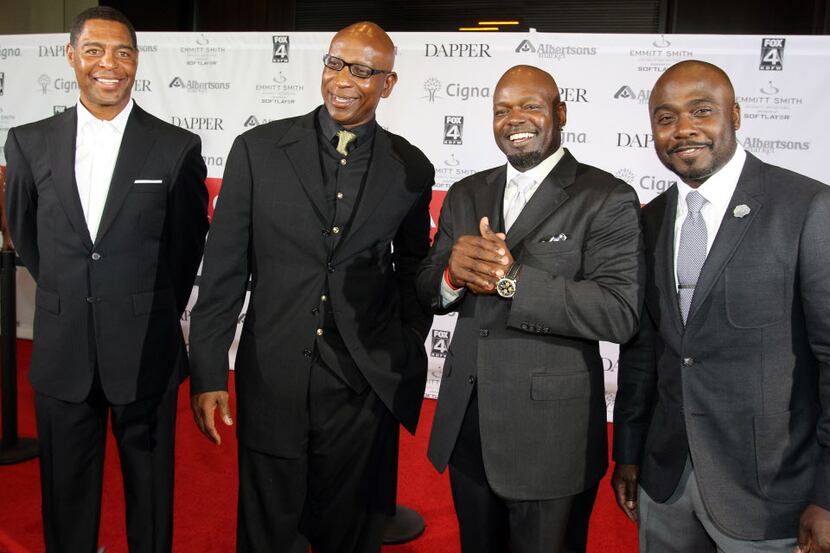 Former Dallas Cowboys running back Emmitt Smith, second from right, shares a laugh with...