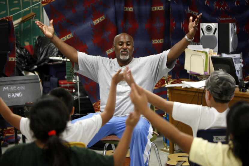 Teacher Osley Cook directed  students in a song during a Thriving Minds summer camp music...