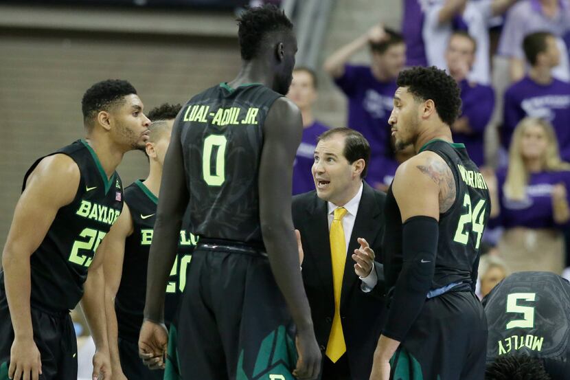 Baylor head coach Scott Drew, second from right, gives directions to his players during the...