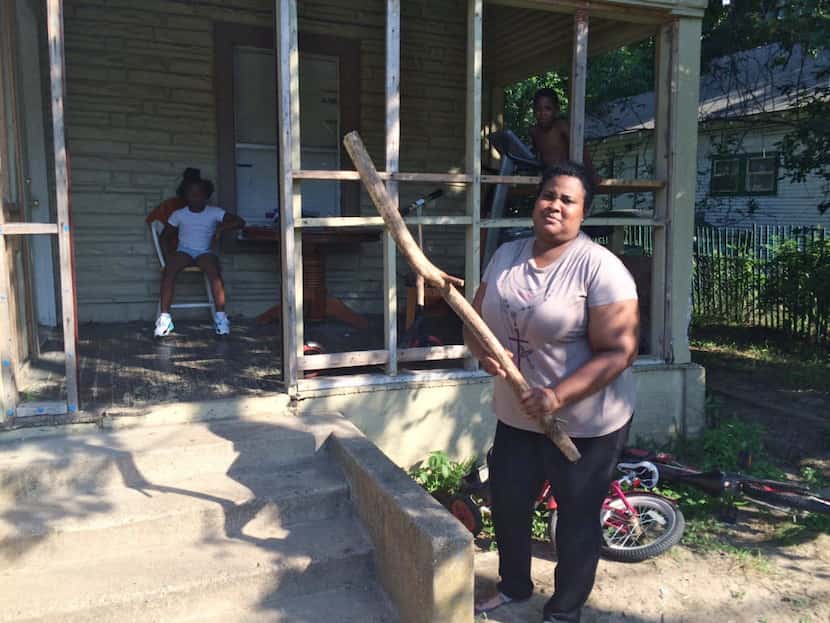 Netra Reese, shown in June, keeps this stick by the porch of her Dallas home for protection...