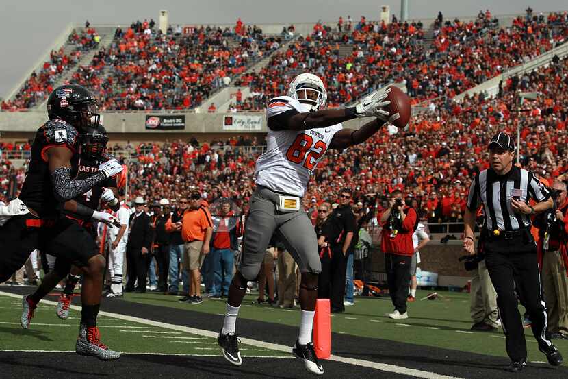 OKLAHOMA STATE 66, TEXAS TECH 6: Isaiah Anderson (82) of Oklahoma State catches a touchdown...