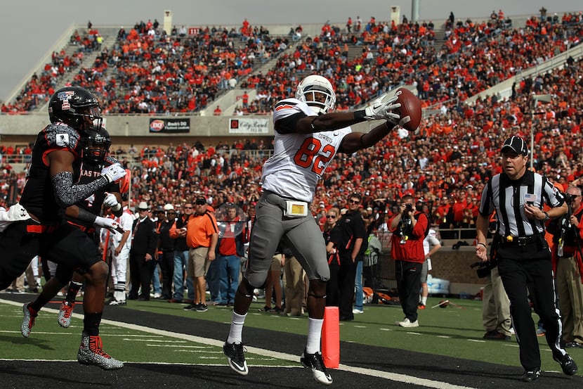 OKLAHOMA STATE 66, TEXAS TECH 6: Isaiah Anderson (82) of Oklahoma State catches a touchdown...