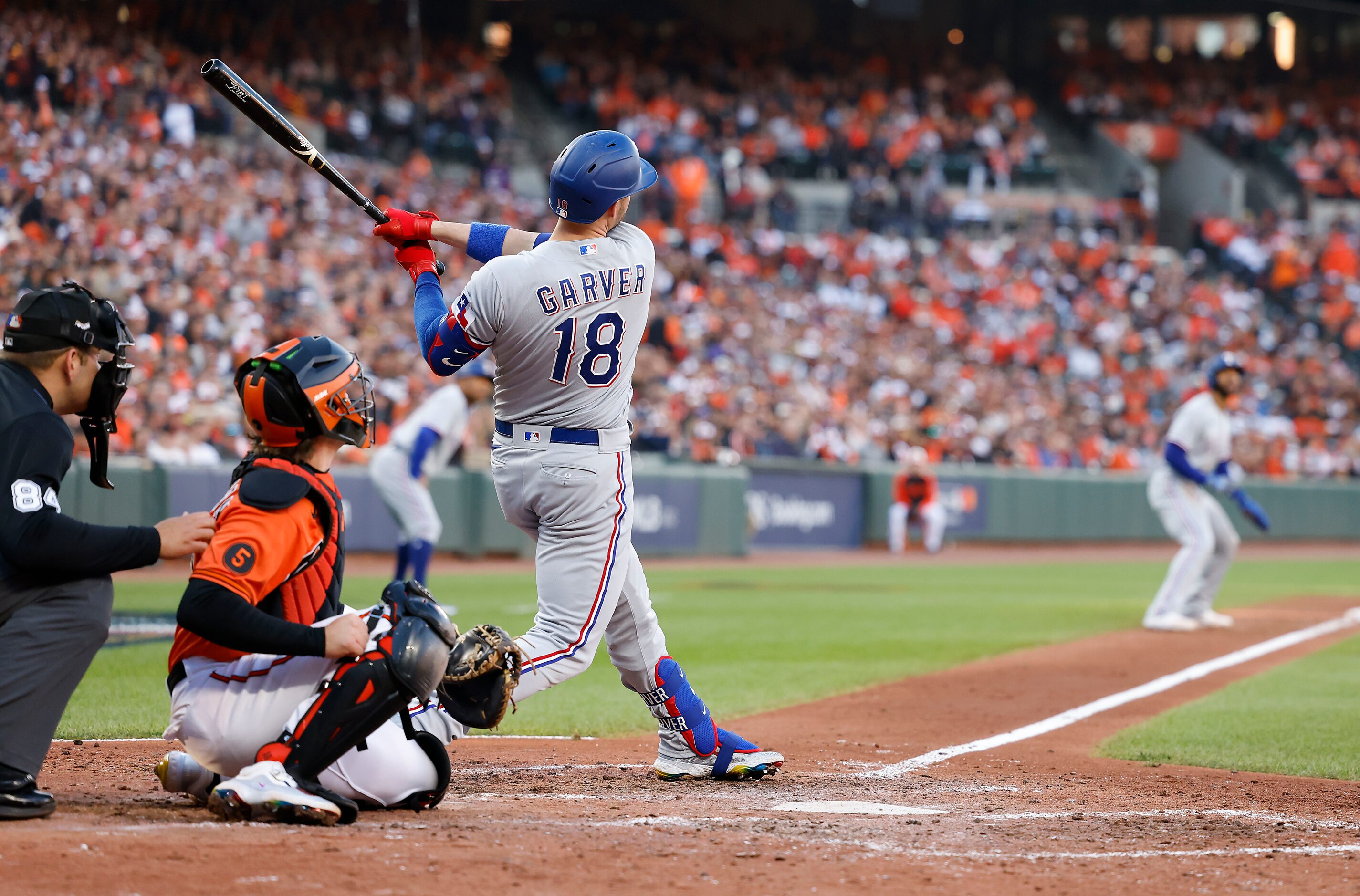 Texas Rangers designated hitter Mitch Garver follows through on a grand slam during the...