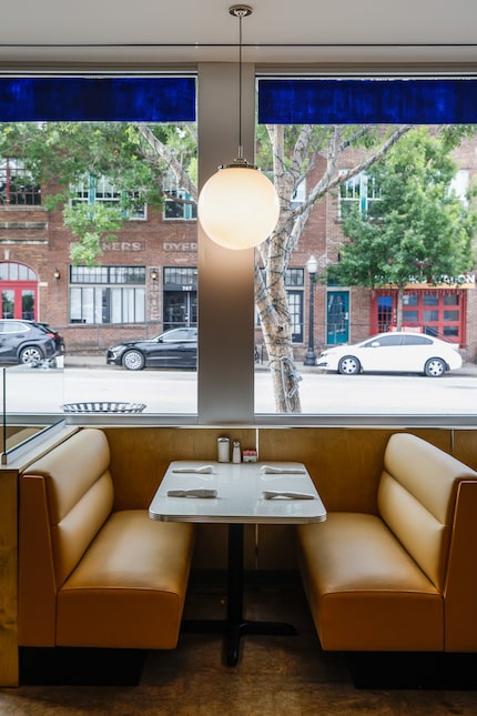 Paris Coffee Shop has tan booths lining the windows and walls.