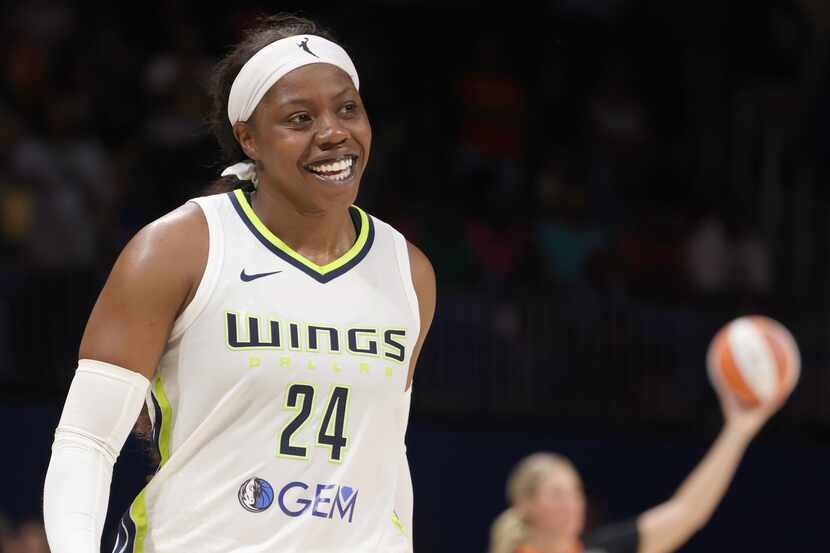 Dallas Wings guard Arike Ogunbowale (24) was all smiles during a possession timeout within...