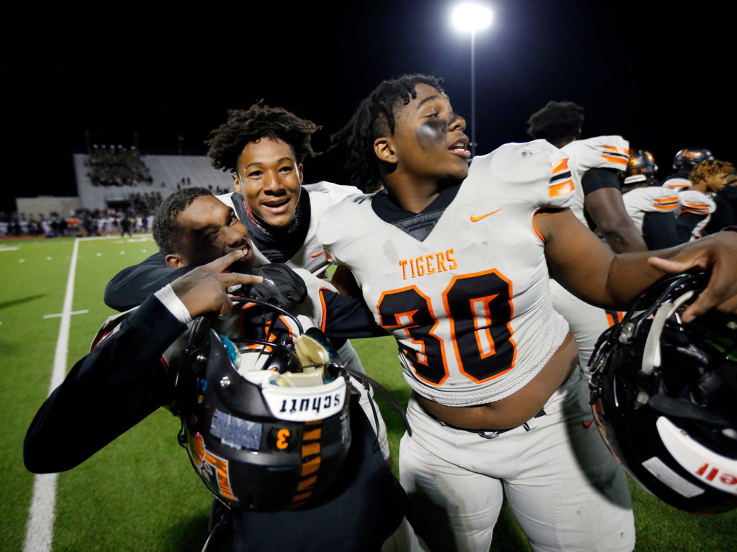 Lancaster's quarterback Glenn Rice Jr (left) celebrates with teammates Kobe Milligan...