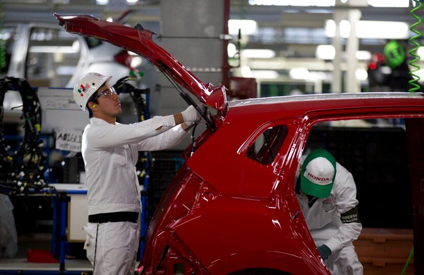 Employees at work in the multibillion-dollar Honda car plant in Celaya, in the central...