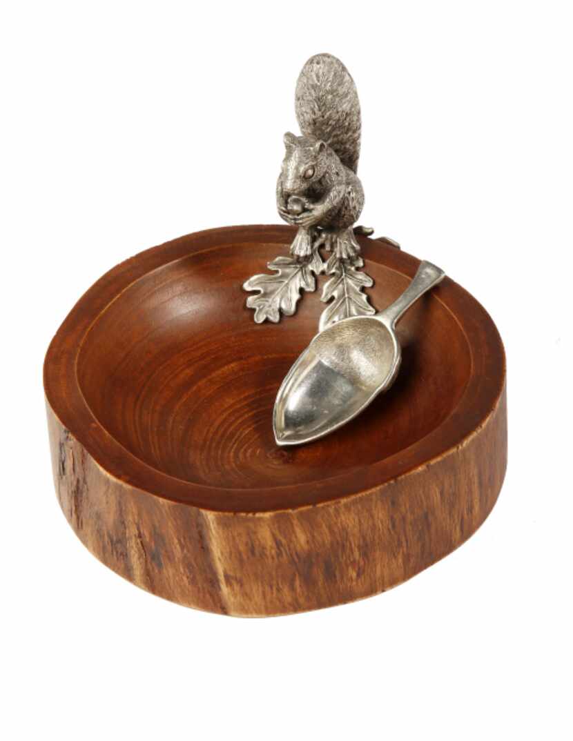 Nuttin' but fun: A wood bowl with a pewter squirrel and spoon, molded on the back like an...