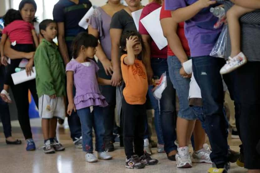 
In this June 20 file photo, immigrants who entered the U.S. illegally stand in line for...