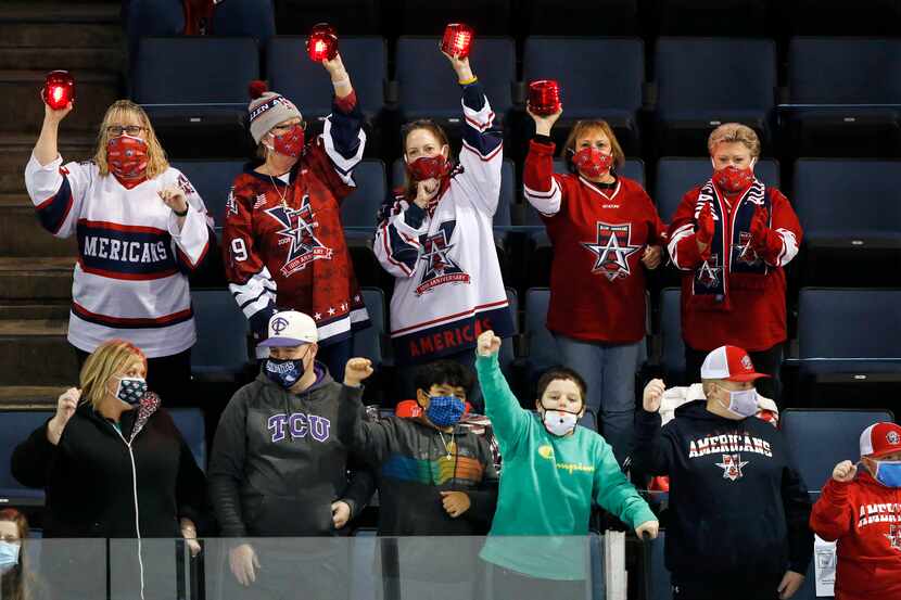 Allen Americans hockey fans celebrate a first period goal during their game against Rapid...