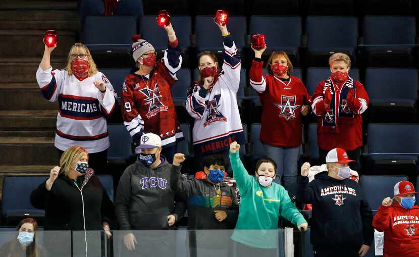 Allen Americans hockey fans celebrate a first period goal during their game against Rapid...