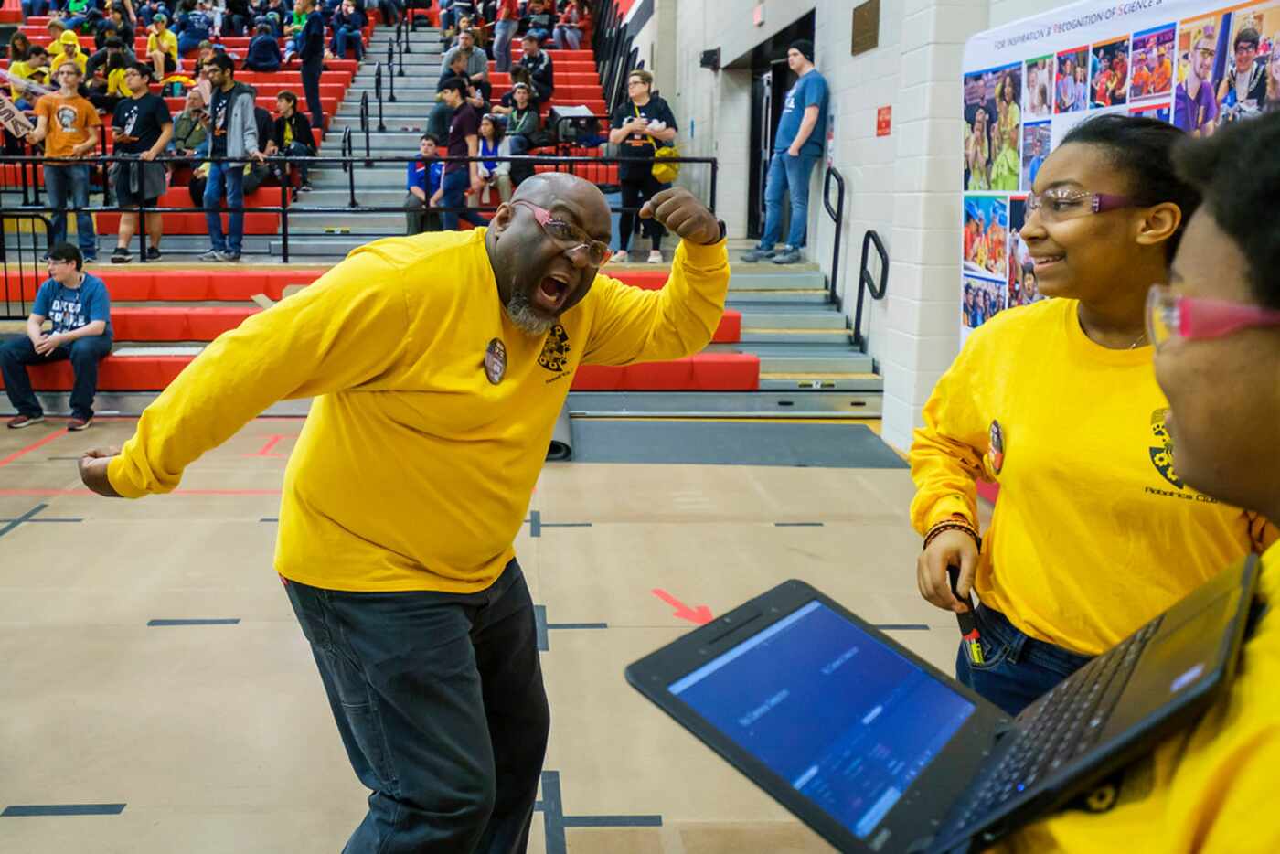 Don Prier horses around with his Spring Woods High School robotics team members before their...