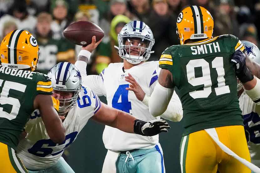 Dallas Cowboys quarterback Dak Prescott (4) throws a pass under pressure from Green Bay...