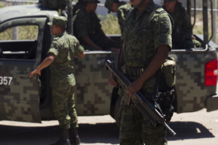 Mexican soldiers patrolled the street in Leon, Mexico, on Thursday in preparation for Pope...