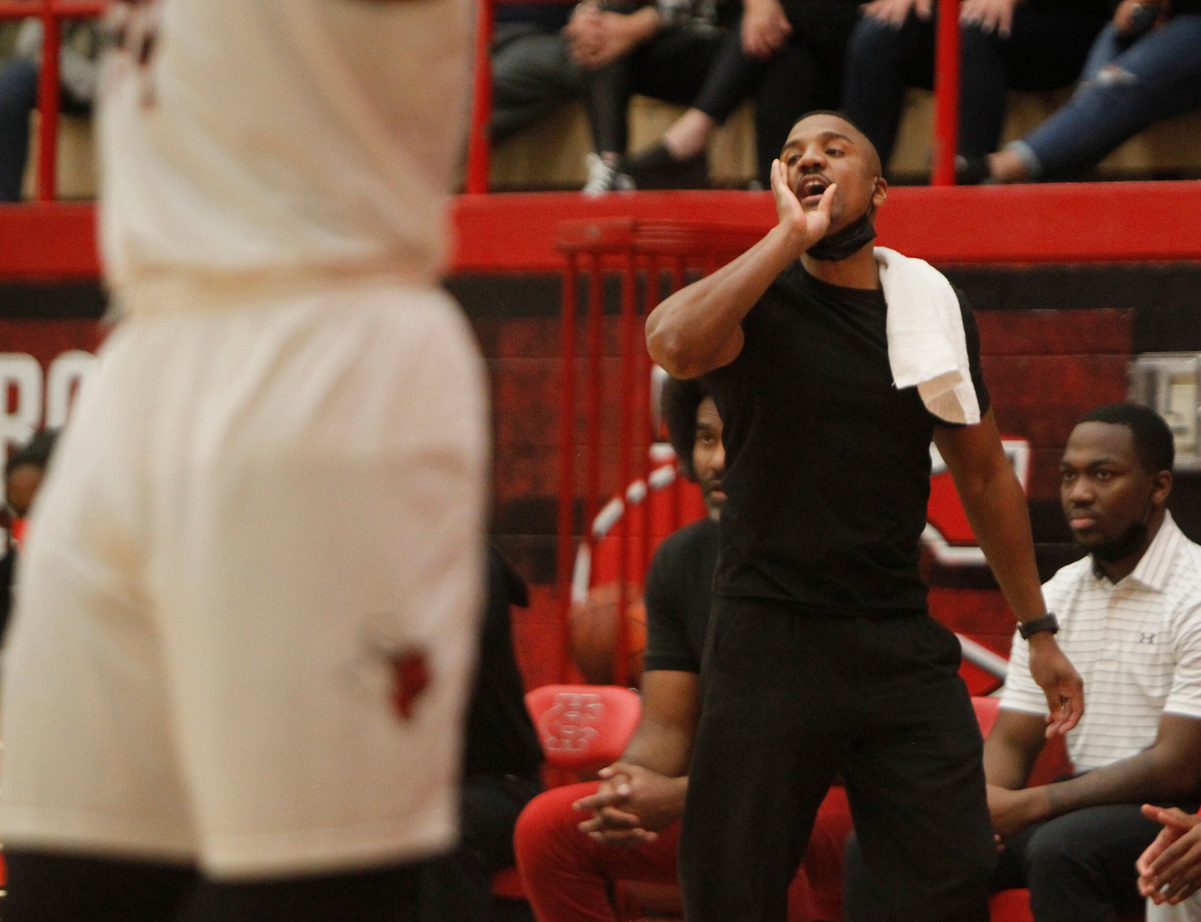 Cedar Hill head coach Corey Chism delivers a message to his players during first half action...