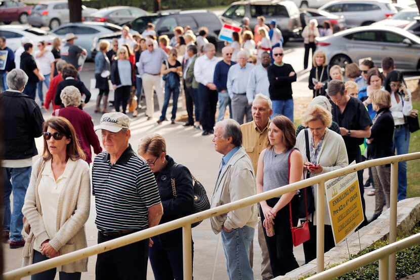 A long line of voters wait to early vote at Our Redeemer Lutheran Church and School on Park...