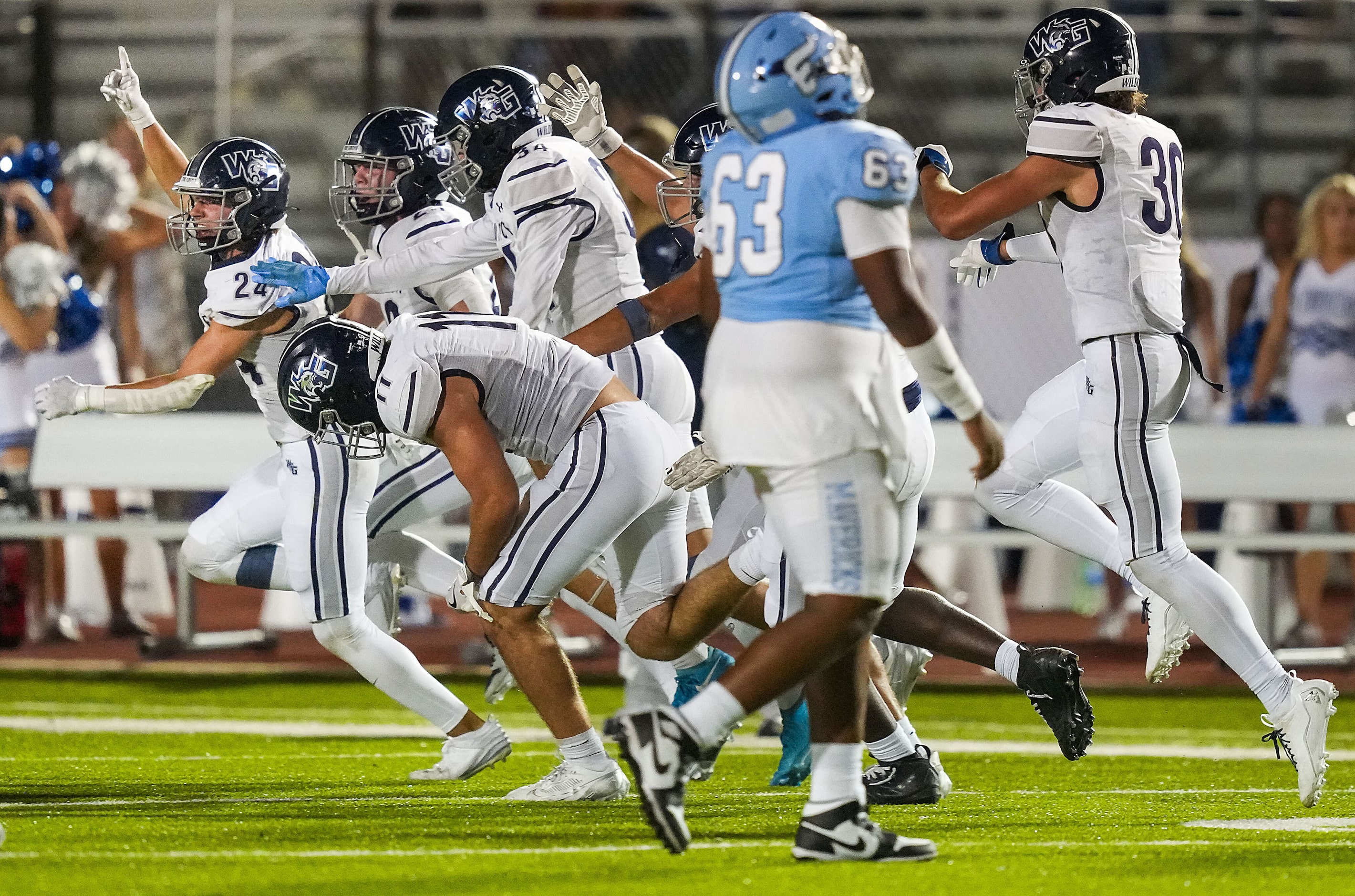 Prosper Walnut Grove defensive back Noah Sallaway (24) celebrates after intercepting a pass...