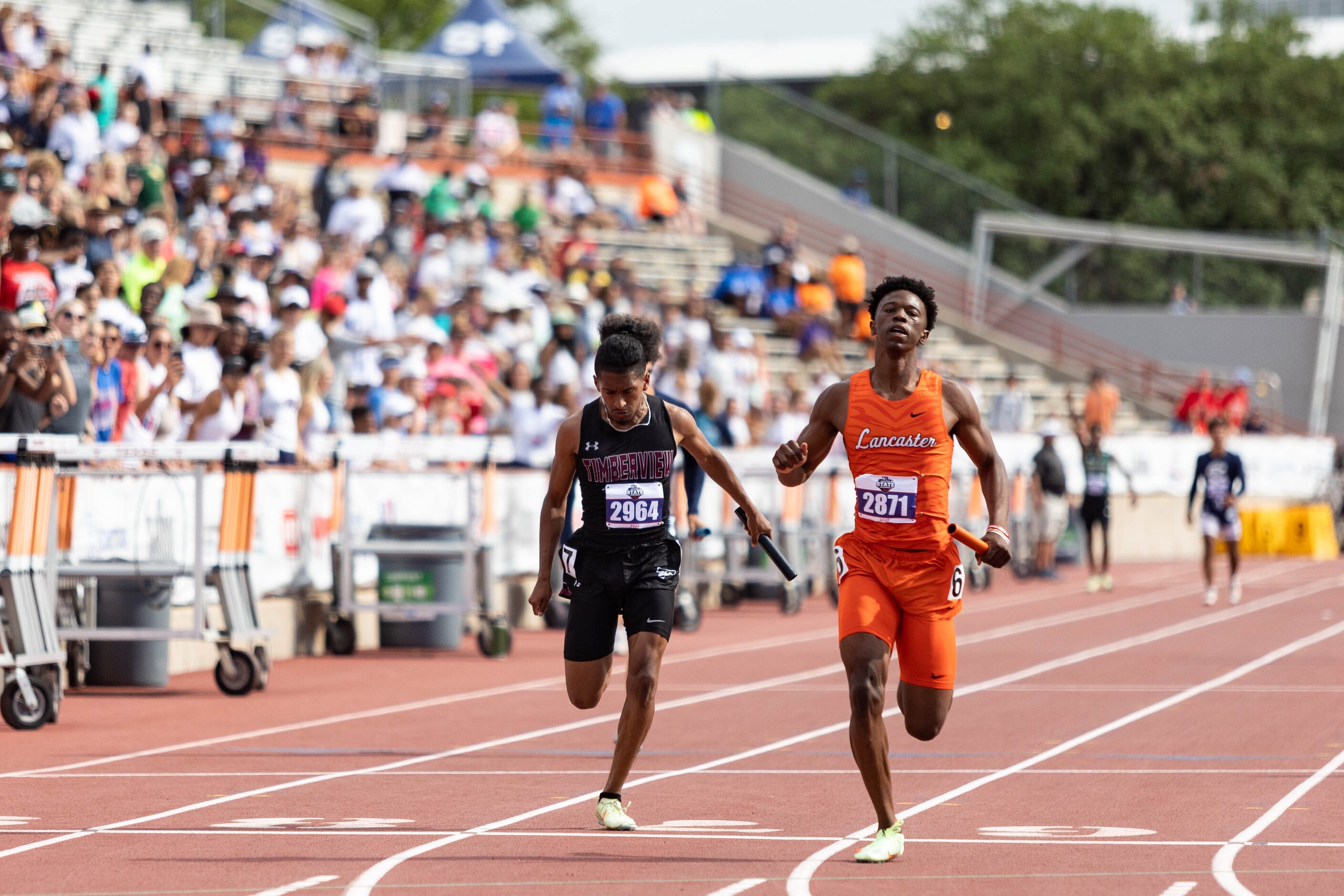 Ethan Moffett of Mansfield Timberview and Corian Gipson of Lancaster race beside each other...