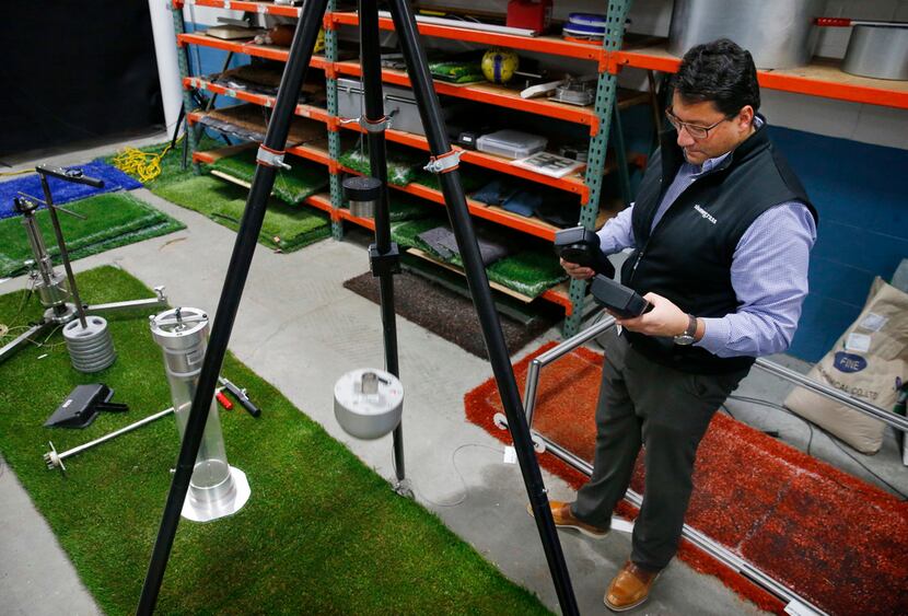 Shaw Sports Turf director of research and innovation Philipe Aldahir performs a HIC (head...
