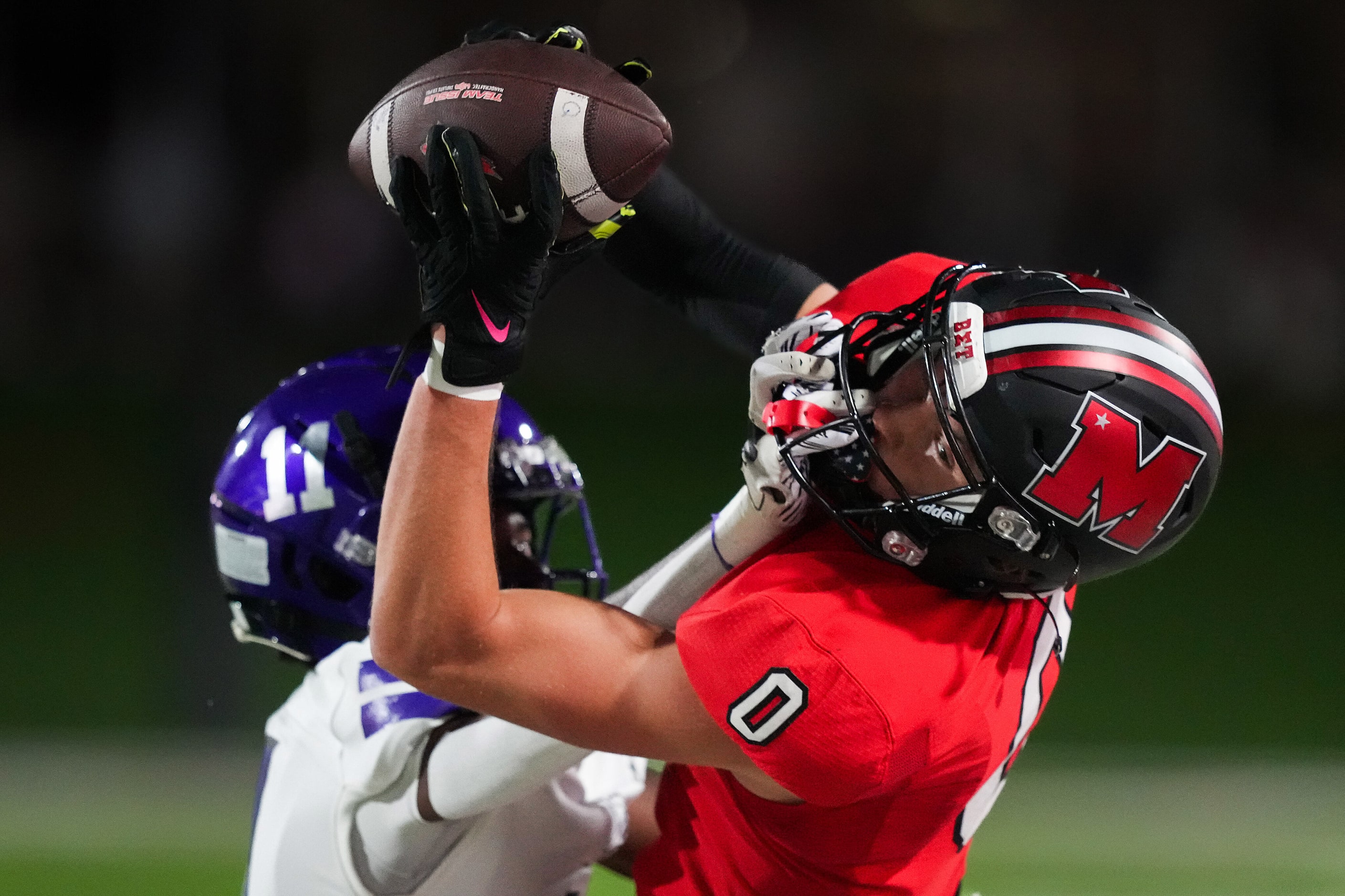 Melissa wide receiver Brett Pool (0) catches a pass as Anna’s Israel Johnson (11) grabs his...