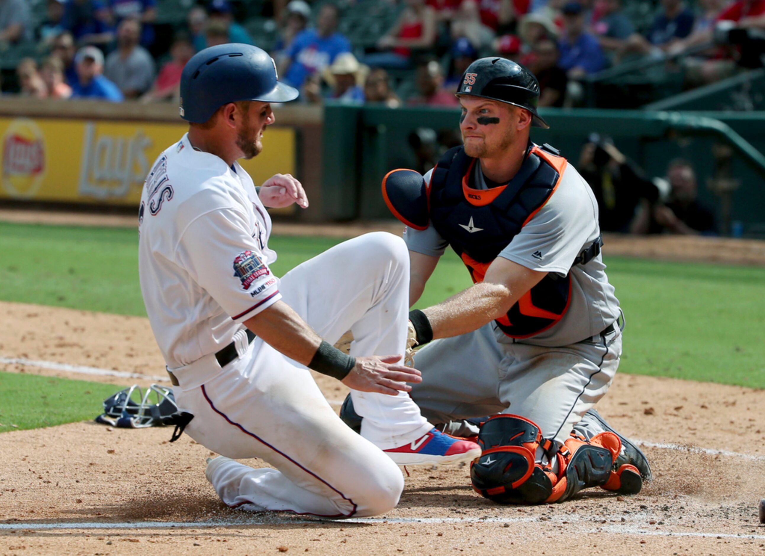 Detroit Tigers catcher John Hicks (55) tags out Texas Rangers Jeff Mathis (2) at home during...