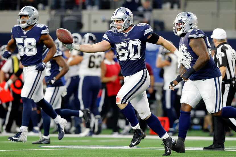 FILE — Dallas Cowboys outside linebacker Sean Lee (50) extends his arm to hand quarterback...