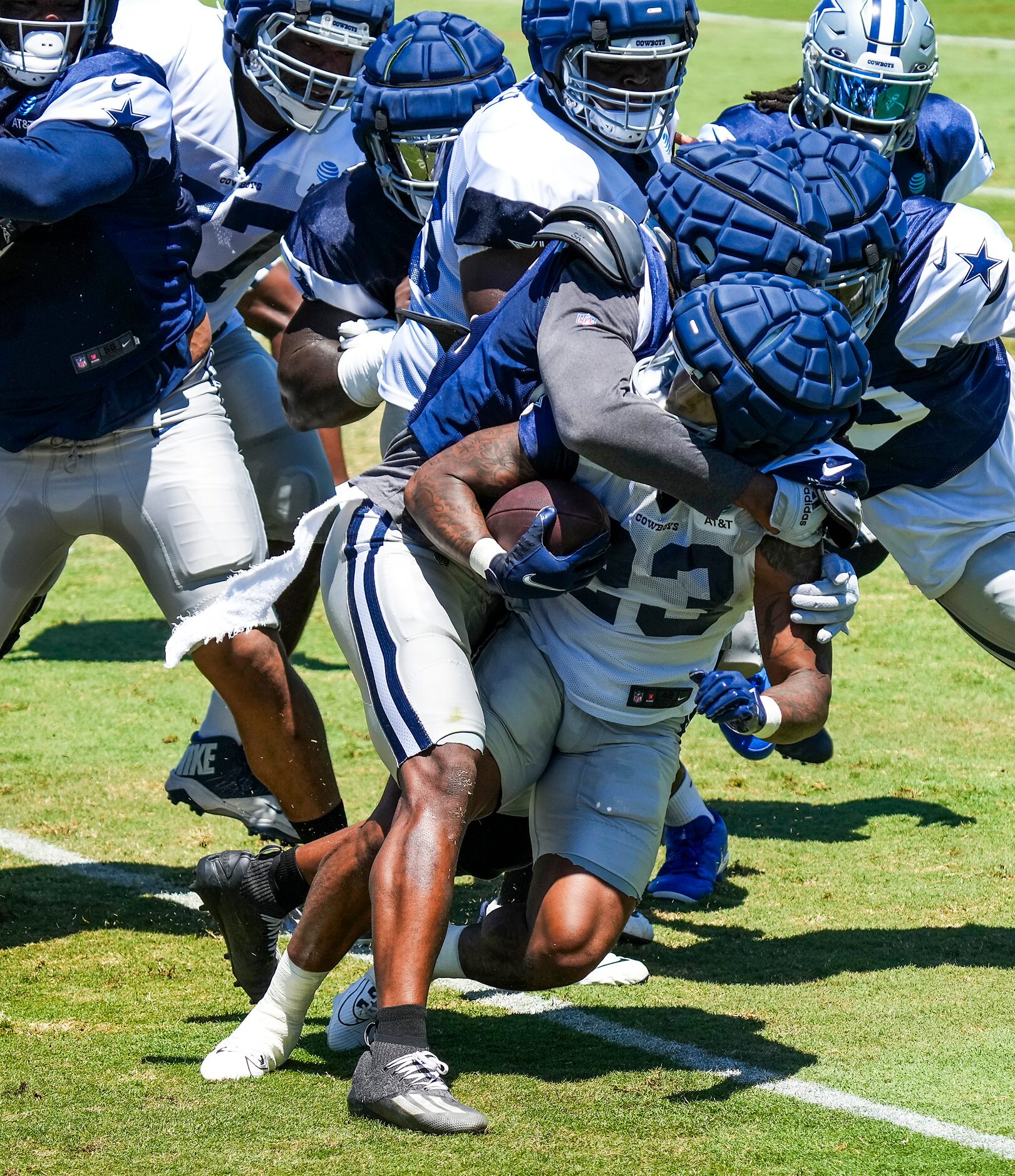 Dallas Cowboys running back Rico Dowdle (23) is wrapped up by defensive end Dante Fowler Jr....