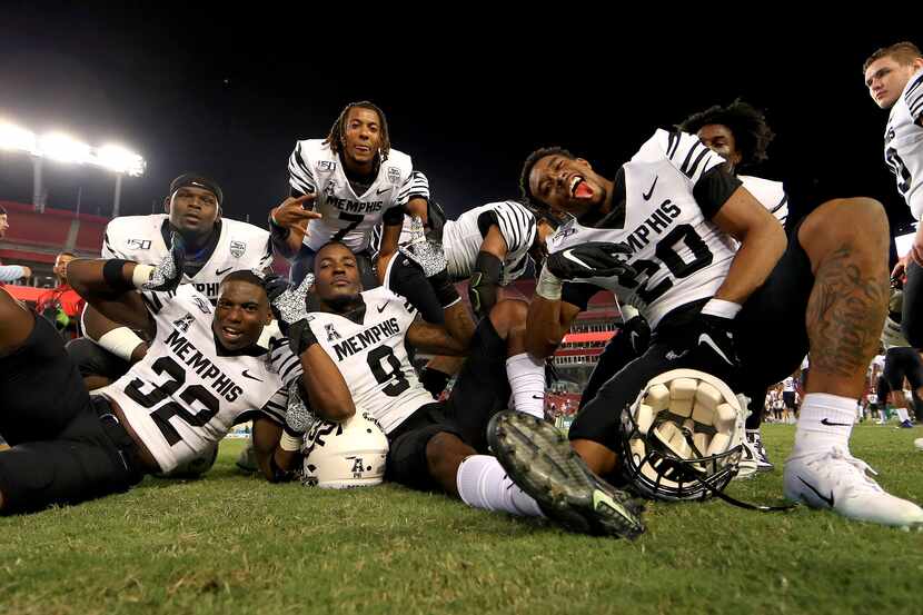 TAMPA, FLORIDA - NOVEMBER 23:  The Memphis Tigers celebrate winning a game against the South...