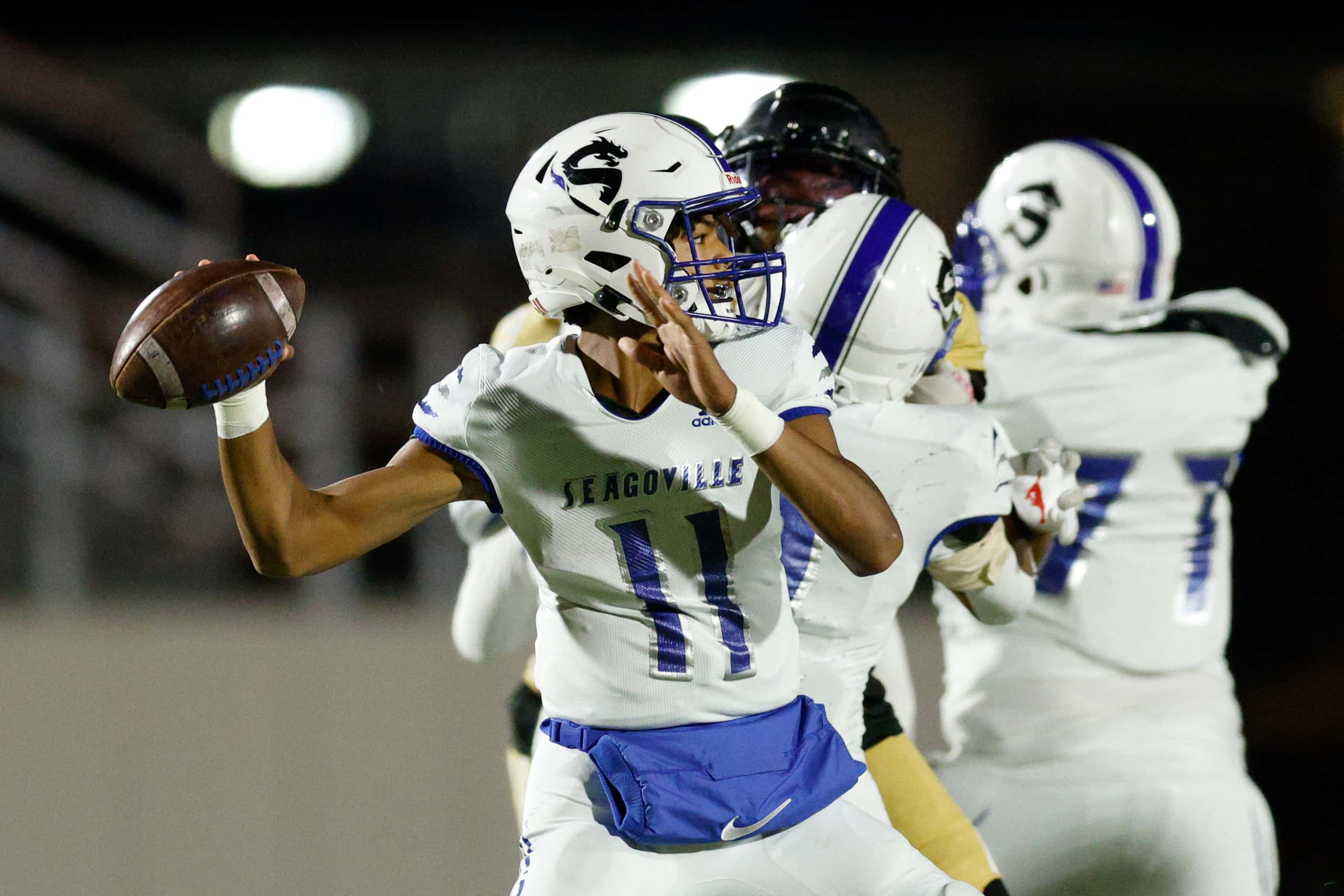 Seagoville quarterback Kaiden Eikelboom (11) throws a pass during the first half of a game...