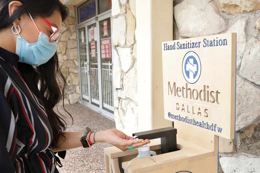 Leslie Cannon tests a newly installed hand sanitizer at Bargain City Bazaar in Dallas on...