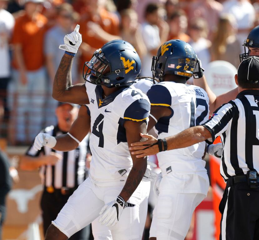 West Virginia Mountaineers running back Kennedy McKoy (4) celebrates a touchdown against...