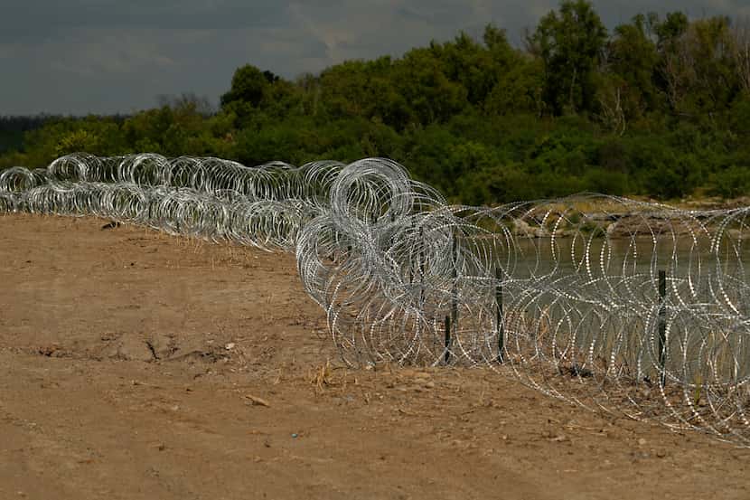 Concertina wire lines the banks of the Rio Grande on the Pecan farm of Hugo and Magali...