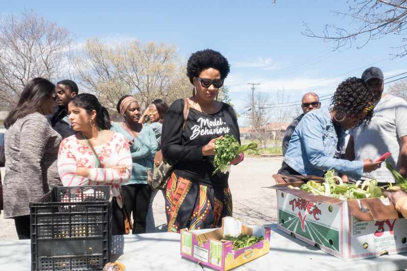 Attendees of the Soul of Dallas Bus tour visit the Oak Cliff Veggie Project in Dallas,...
