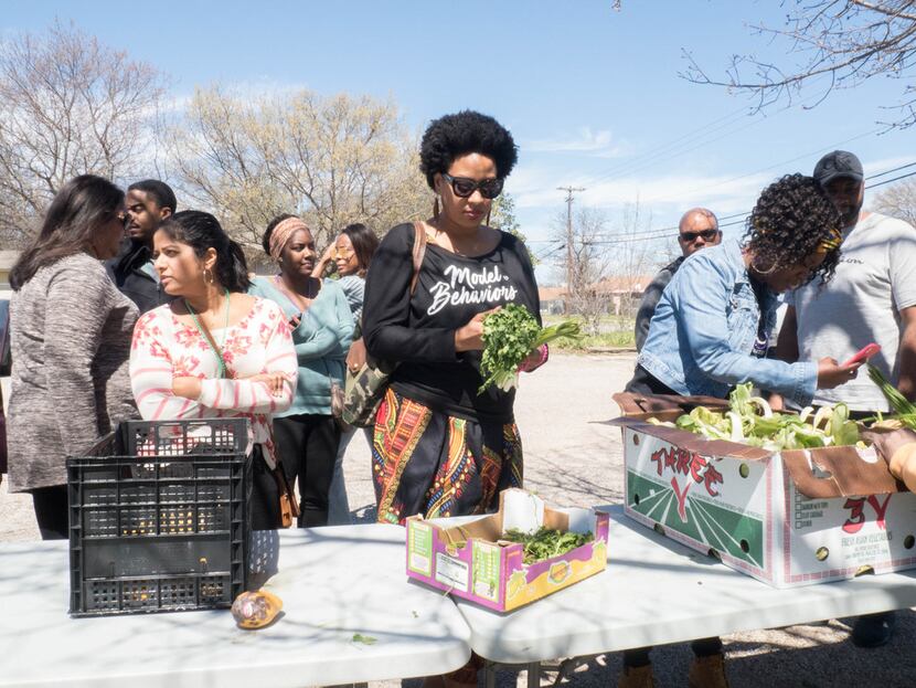 Attendees of the Soul of Dallas Bus tour visit the Oak Cliff Veggie Project in Dallas,...