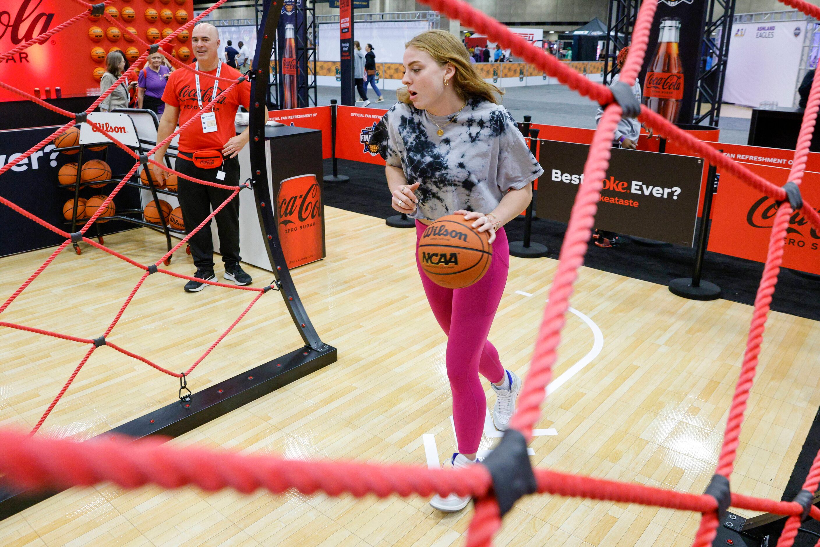 Laci Steele, 18, competes in a skills challenge at a Coca-Cola Zero booth during the NCAA...