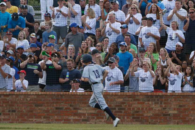 Northwest Eaton's Kolton Graham (13) dashes past the cheer of the fans after scoring in the...