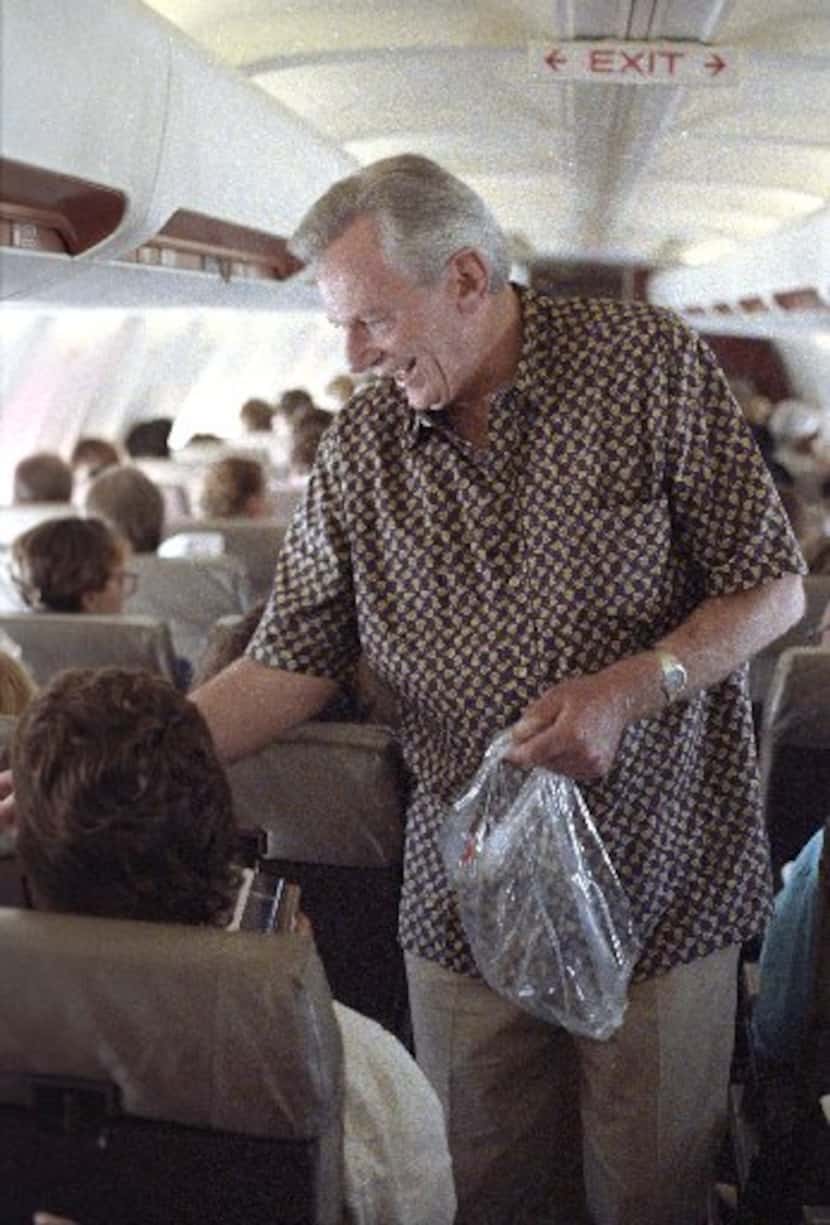 Southwest Airlines chief Herb Kelleher passes out peanuts to customers on a flight from...