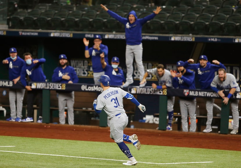 Los Angeles Dodgers designated hitter Joc Pederson rounds the bases after hitting a solo...