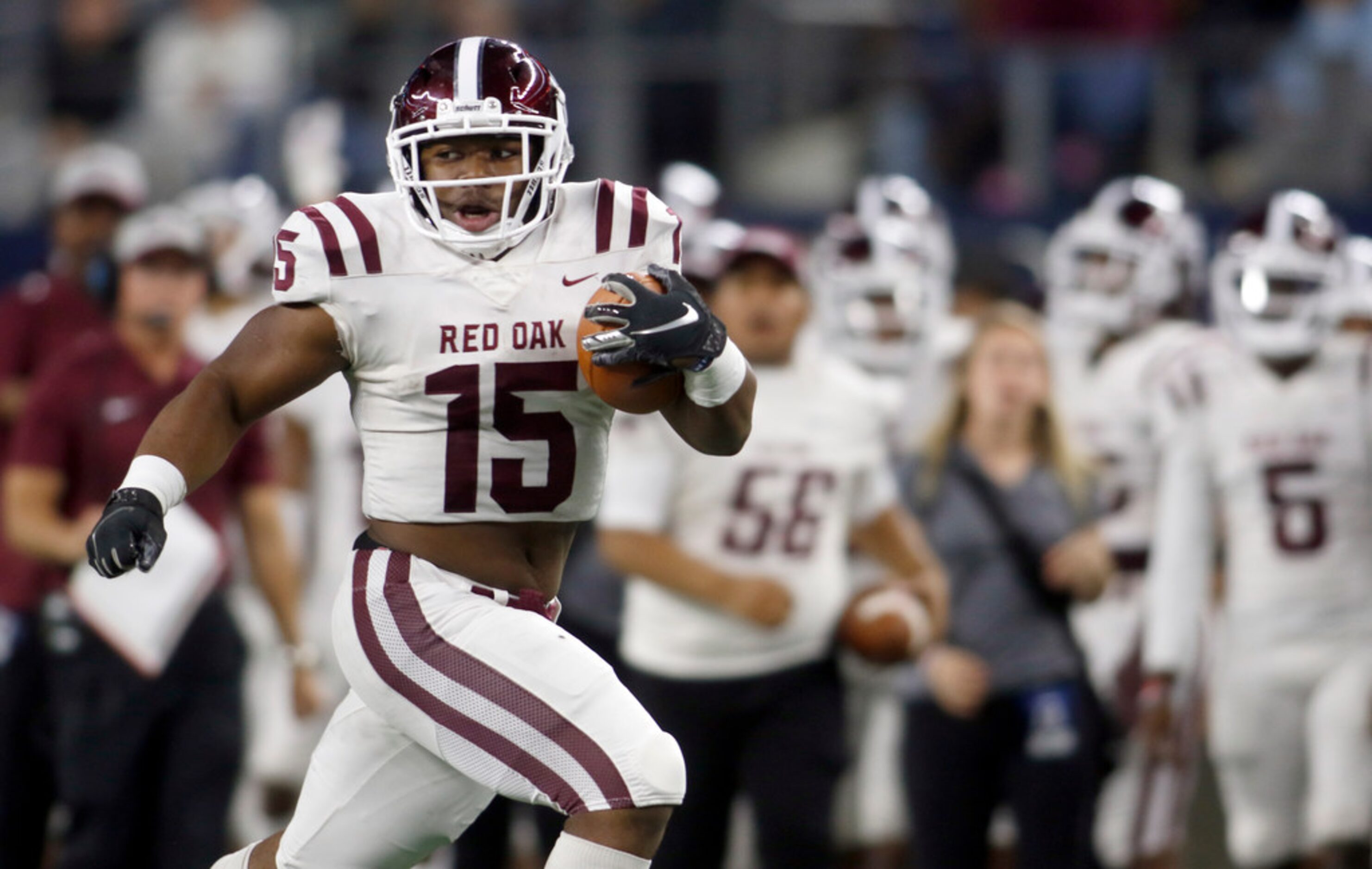 Red Oak running back C.J. Palmer (15) looks over his shoulder as he rambles deep into the...