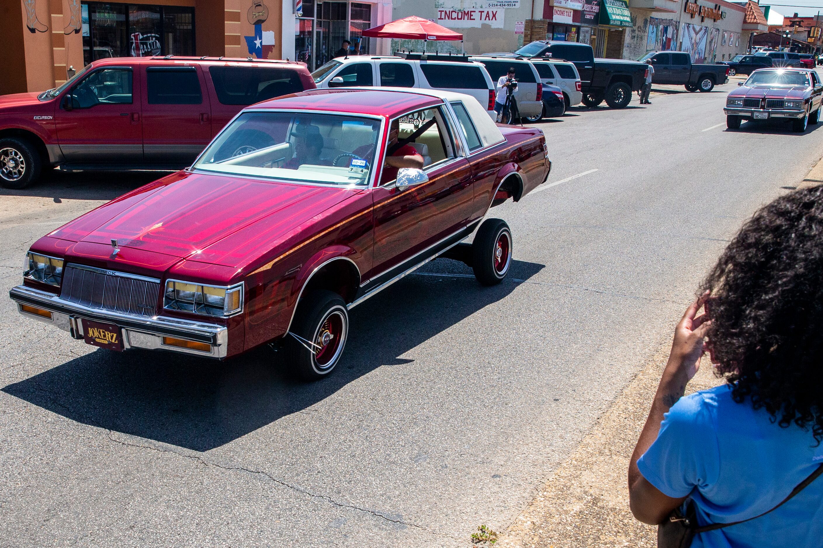 The United Lowriders Association of Dallas drive along the Jefferson Boulevard business...