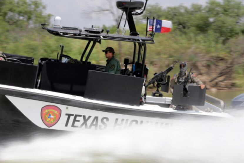 
Texas Department of Safety Troopers patrol on the Rio Grande along the U.S.-Mexico border...