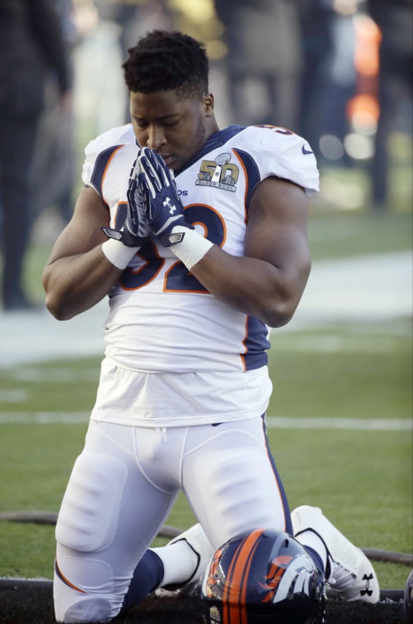 Denver Broncos’ Corey Nelson prays before the NFL Super Bowl 50 football game against the...